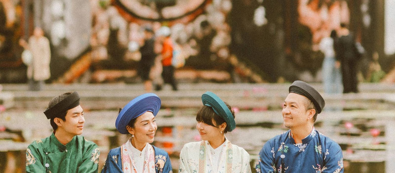 A family in traditional Vietnamese dress at a heritage courtyard